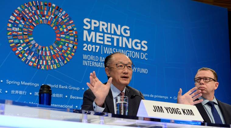 World Bank President Jim Yong Kim gestures as he makes remarks during a press briefing to open the IMF and World Bank's 2017 Annual Spring Meetings, as press spokesman David Theis listens, in Washington